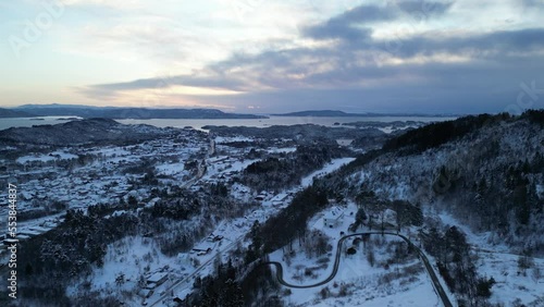 Sunset over Norwegian coastal landscape. Winter, mountains and fjord.