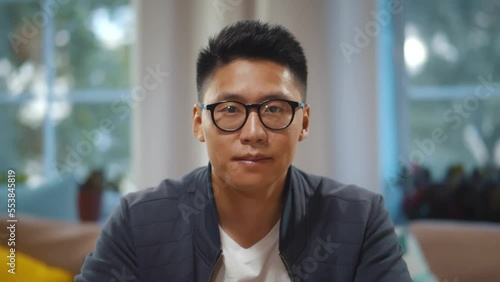 Smiling young asian man vlogger look at camera talk make live video conference. Realtime