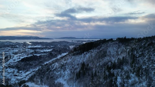 Sunset over Norwegian coastal landscape. Winter, mountains and fjord.