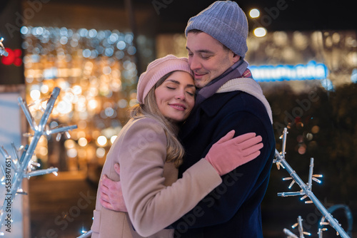 Romantic couple is having fun outdoors in winter before Christmas. Enjoying spending time together in New Year Eve