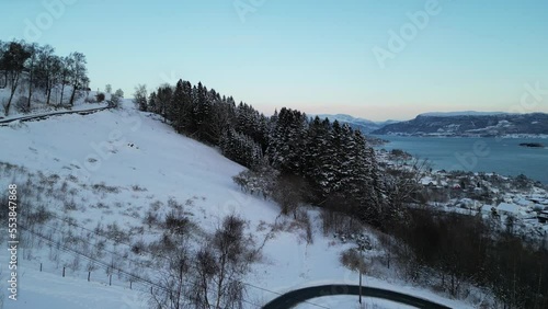 Sunset over Norwegian coastal landscape. Winter, mountains and fjord.