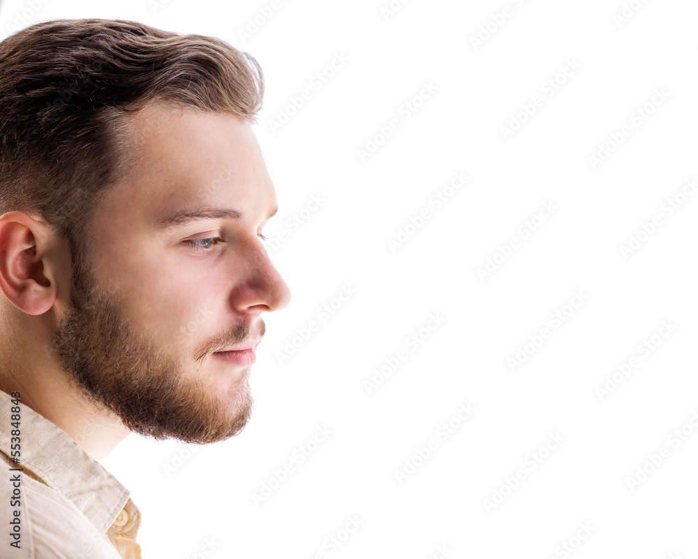 Obraz premium Side-view portrait of young bearded caucasian male isolated on white background