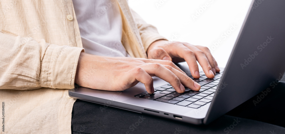 Male hands on laptop keyboard isolated on white background Male hands on laptop keyboard isolated on white background