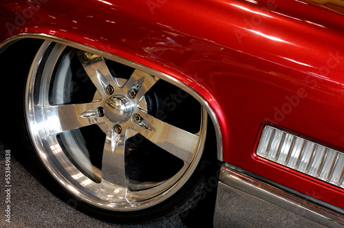 Cool chrome low profile wheel rim on a classic vintage custom red car photo