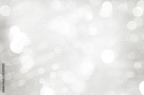 Elegant Abstract Silver Christmas Background with white bokeh lights for Holiday Poster, Banner, Ad, Card or invitation.