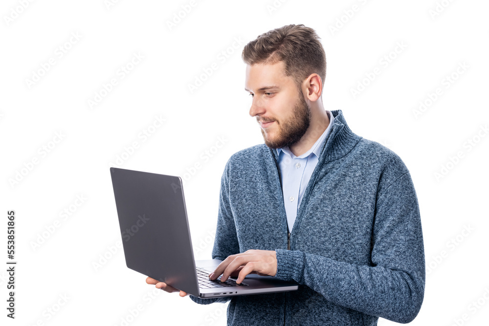 Young bearded male holding laptop, standing on white backgound, studio shot Young bearded male holding laptop, standing on white backgound, studio shot