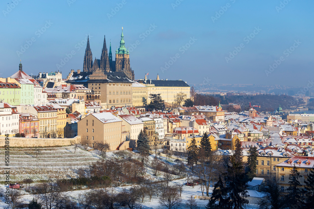 Snowy Prague City with gothic Castle from Hill Petrin in the sunny Day, Czech republic