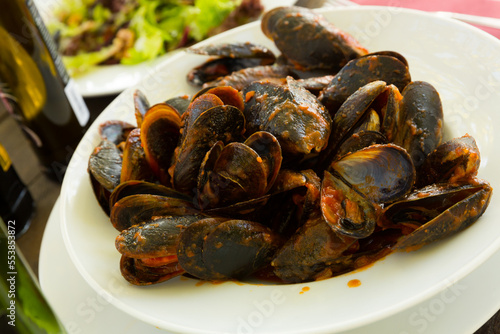 Delicious seafood mussels with tomato sauce on plate