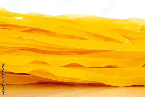 Homemade raw noodles, macro, isolated on white background.