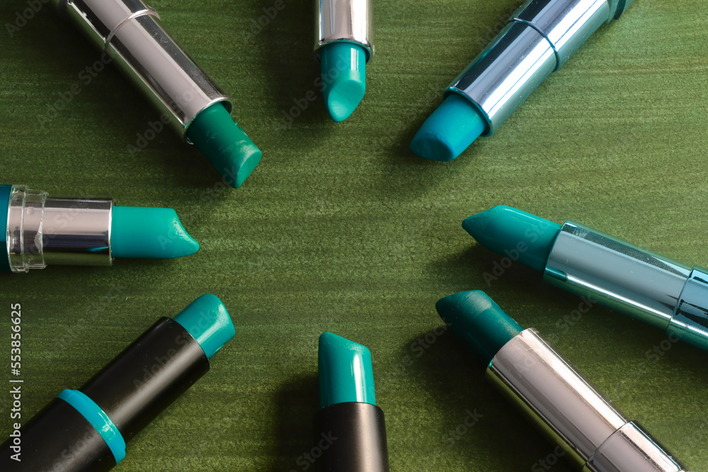 green lipsticks in a circle on a green background green lipsticks in a circle on a green background