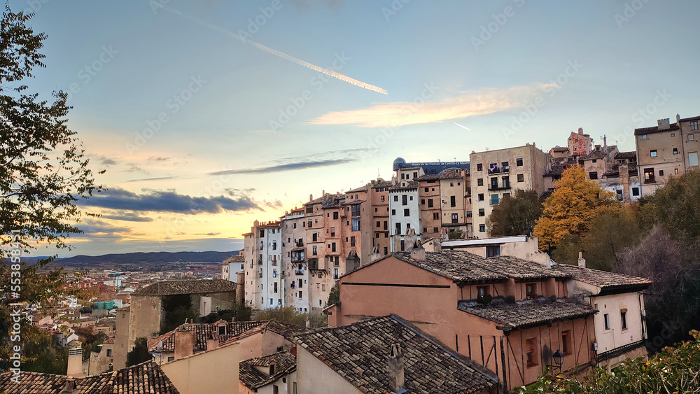 sunset in Cuenca, Spain, with landscape of skyscraper buildings, a cloudless blue sky and the old city in the background - touristic postcard for a wallpaper