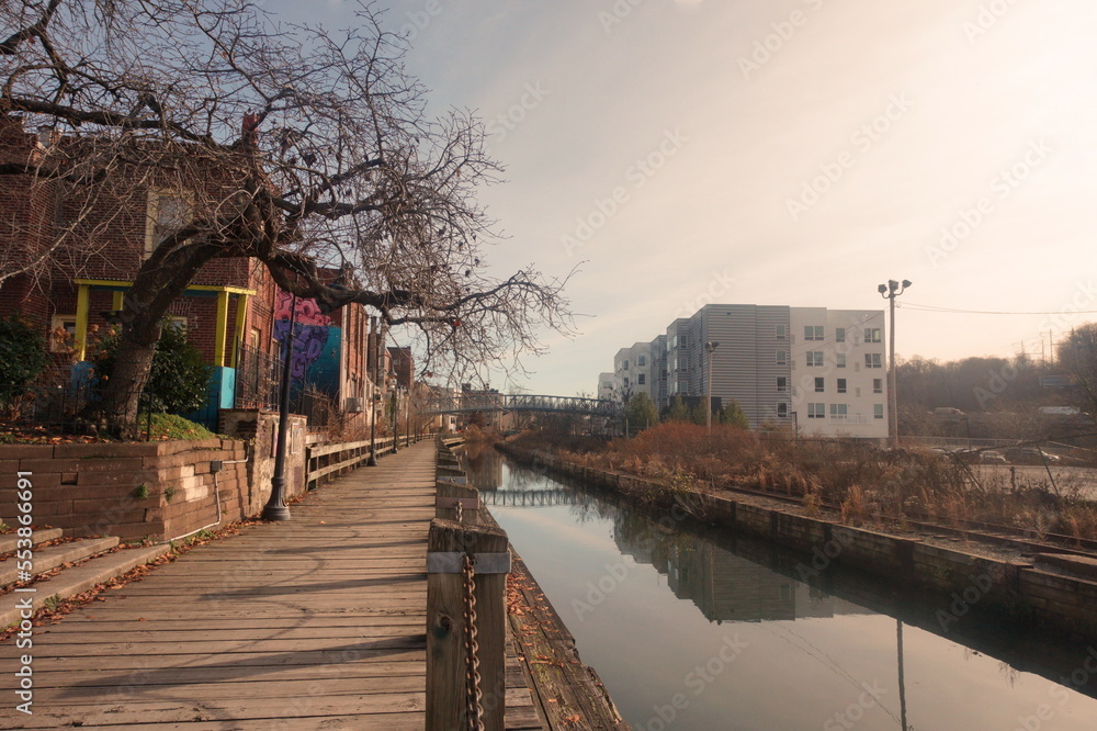 Obraz premium Boardwalk By City Canal on Winter Day