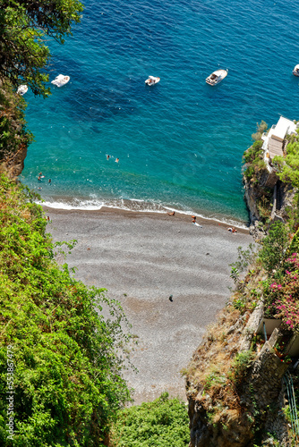 Top view of a narrow intimate bay along the Amalfi Coast with turquoise sea and lush nature in a tropical style photo