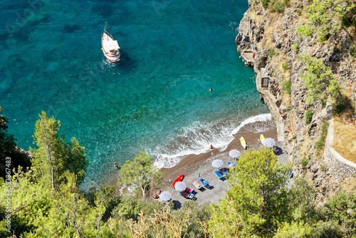 Top view of a narrow intimate bay along the Amalfi Coast with turquoise sea and lush nature in a tropical style photo