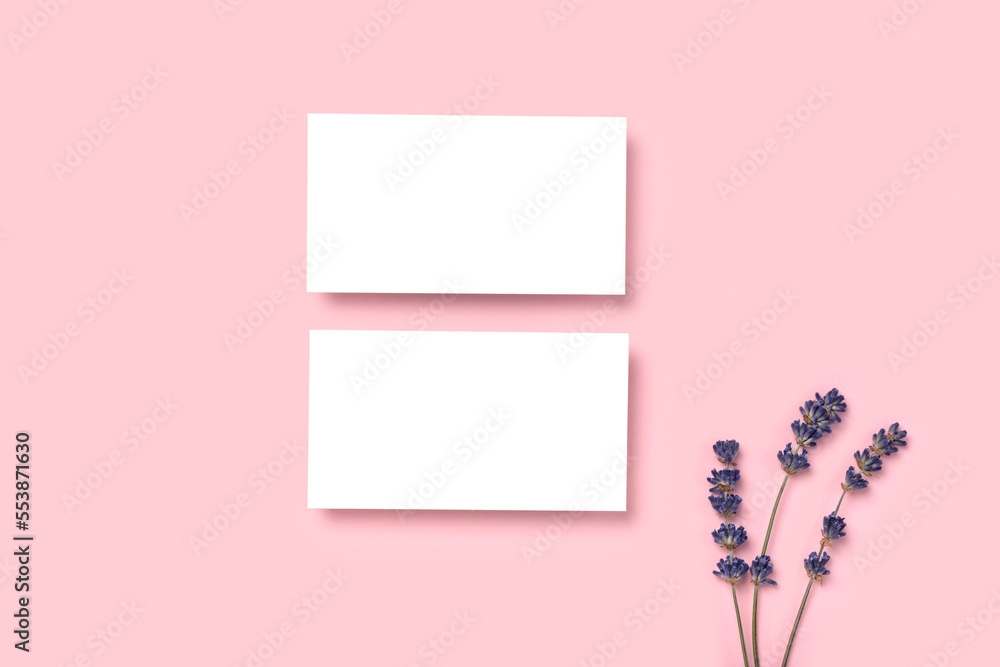 Mockup two cutaway, discount, business card on a pink minimalism background and lavender flowers with copy space. Template for design Mockup two cutaway, discount, business card on a pink minimalism background and lavender flowers with copy space. Template for design