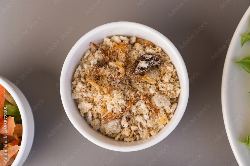 Delicious cassava farofa. Top view. Typical Brazilian food. Selective focus Delicious cassava farofa. Top view. Typical Brazilian food. Selective focus