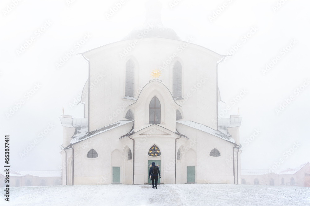 A person walking towards Pilgrimage Church of St. John of Nepomuk at Zelena hora, Zdar nad Sazavou (Žďár nad Sázavou in czech language) in winter weather. A person walking towards Pilgrimage Church of St. John of Nepomuk at Zelena hora, Zdar nad Sazavou (Žďár nad Sázavou in czech language) in winter weather.