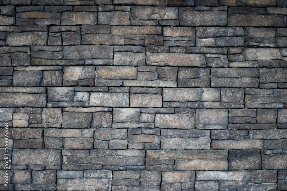 slate rock wall with dark colors