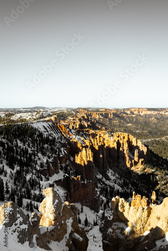 Desaturated monochrome fine art photo style of bryce canyon national park during the day in winter with snow on ground