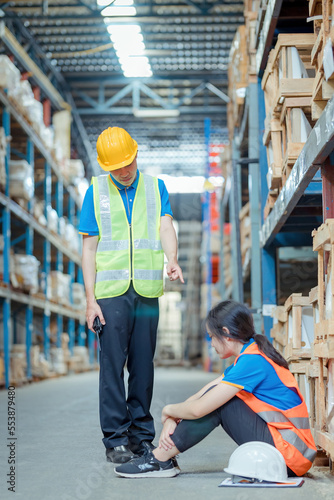 Warehouse worker being scolded and admonished by the supervisor ,Warehouse worker checking packages on shelf in a large store.