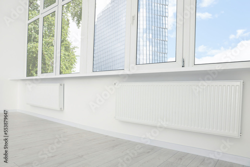 Modern office room with radiators and windows. Interior design