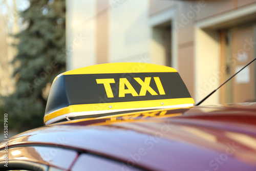 Roof light with word TAXI on car outdoors