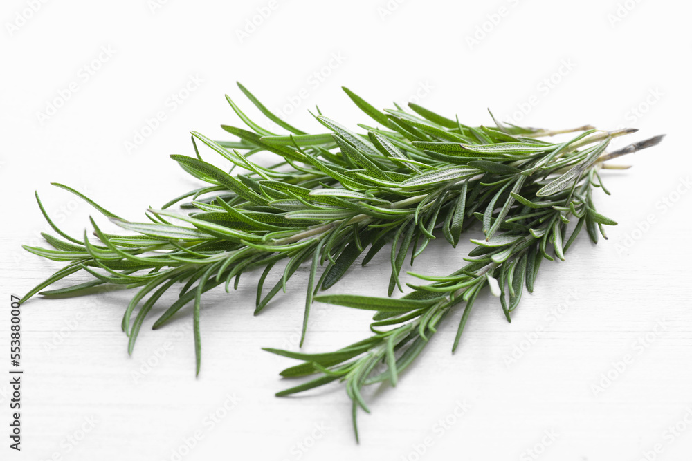 Fresh green rosemary twigs on white wooden table, closeup Fresh green rosemary twigs on white wooden table, closeup