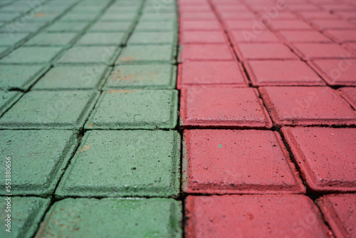 red green color paving block slabs in city, pedestrian street, pavement texture, tiled pathway