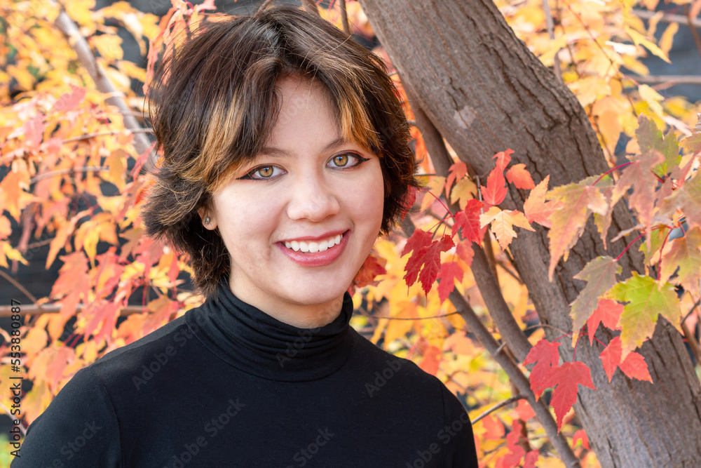 A close portrait of a young girl on the background of autumn scenes A close portrait of a young girl on the background of autumn scenes