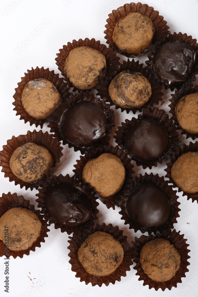 Closeup of chocolate truffles, some chocolate coated, some dusted with cocoa powder Closeup of chocolate truffles, some chocolate coated, some dusted with cocoa powder