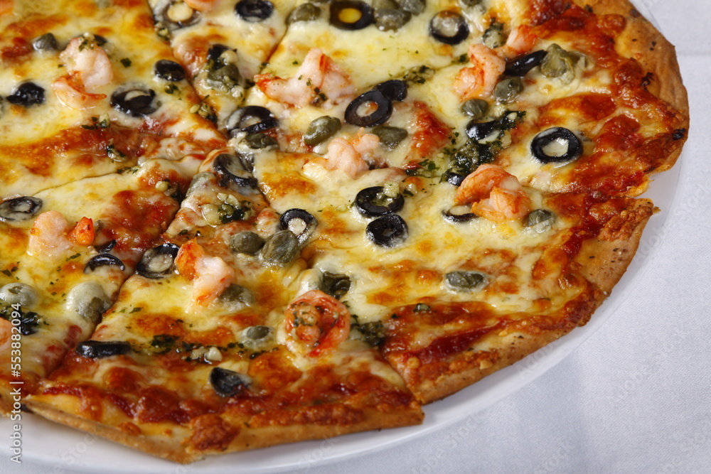 Cheesy seafood pizza with shrimp, bacon, olives, bell peppers, tomato Cheesy seafood pizza with shrimp, bacon, olives, bell peppers, tomato