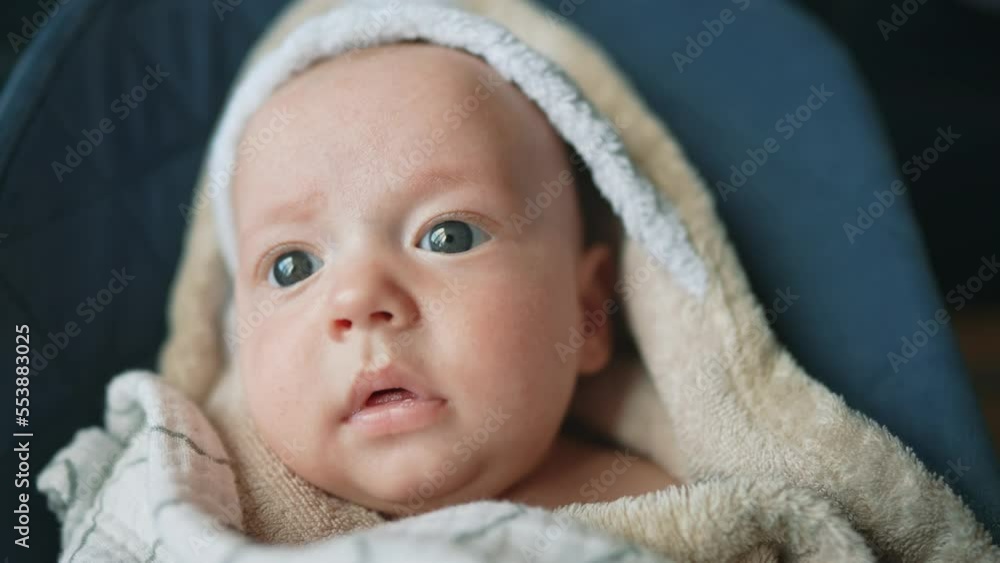 newborn baby swinging in a rocking chair. happy family kid dream concept. baby newborn close-up looking at the camera. lifestyle child infant wrapped in a towel swinging on a sun lounger rocking chair newborn baby swinging in a rocking chair. happy family kid dream concept. baby newborn close-up looking at the camera. lifestyle child infant wrapped in a towel swinging on a sun lounger rocking chair