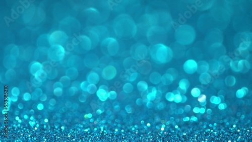 Blue Christmas background. Shiny blue surface rotates. Magic bokeh background