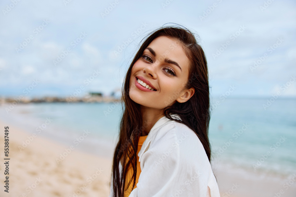 Portrait of a happy woman smile with teeth with long hair brunette summer travel and feeling of freedom, balance Portrait of a happy woman smile with teeth with long hair brunette summer travel and feeling of freedom, balance