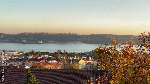 Alfama in autumn season along the river Tagus in Lisbon. Trees with autumn coloured leaves.