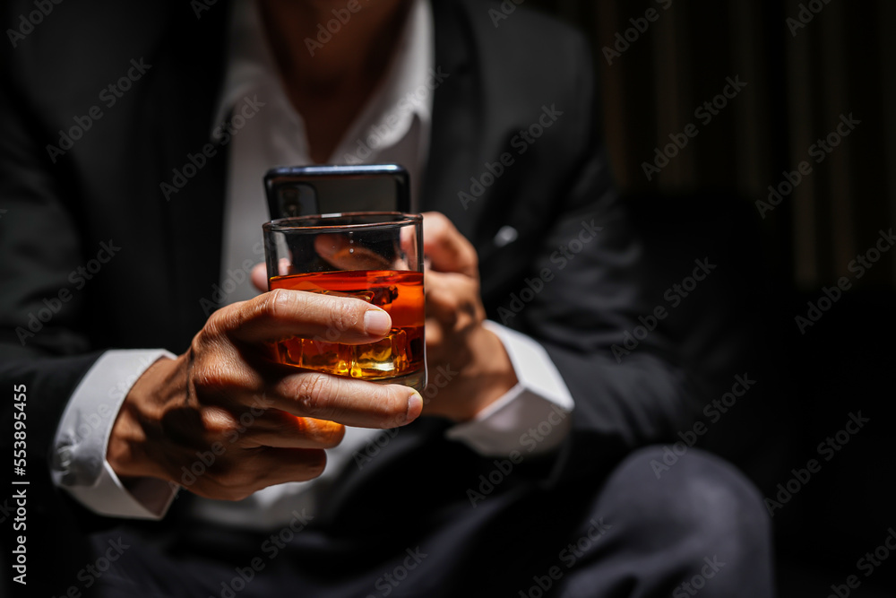 Closeup businessmen holding a glass of whiskey Closeup businessmen holding a glass of whiskey