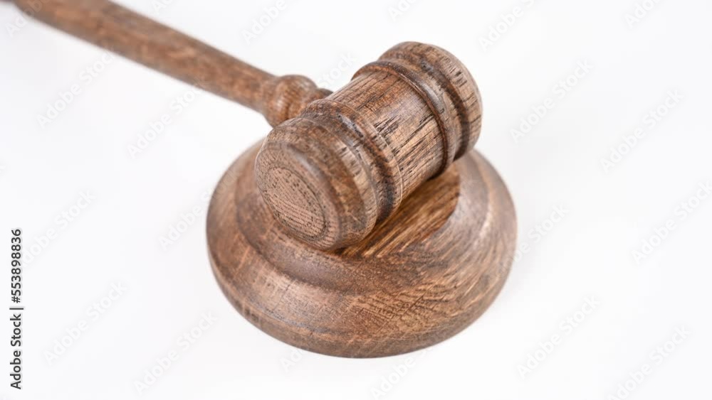 Wooden judge's gavel spinning on a white background. Top view. Wooden judge's gavel spinning on a white background. Top view.