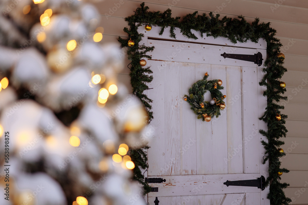 Wooden white house door with green wreath Wooden white house door with green wreath