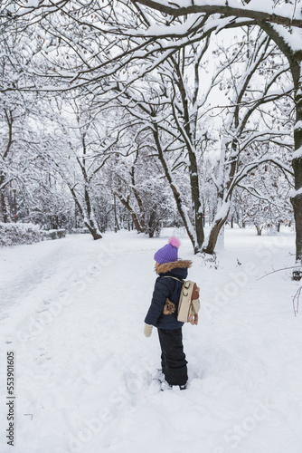 A child returning from kindergarten in winter 