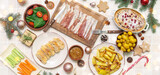 Different tasty dishes for Christmas dinner on light background