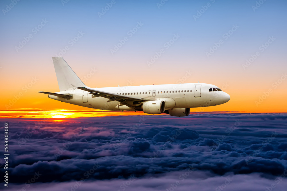 White passenger airplane fly in the sunrise sky White passenger airplane fly in the sunrise sky