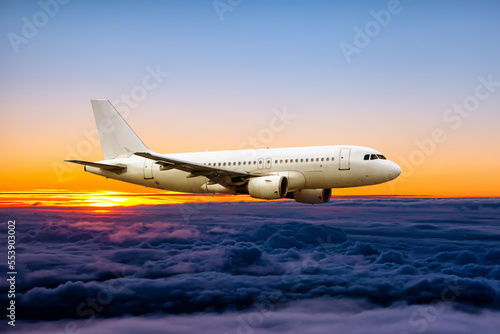 White passenger airplane fly in the sunrise sky