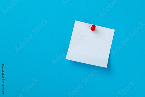 Blank sticky note on blue background