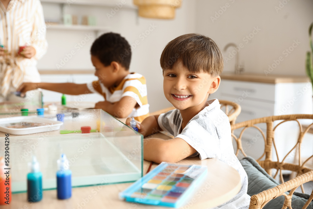 Little boy sitting at table in workshop for Ebru painting Little boy sitting at table in workshop for Ebru painting