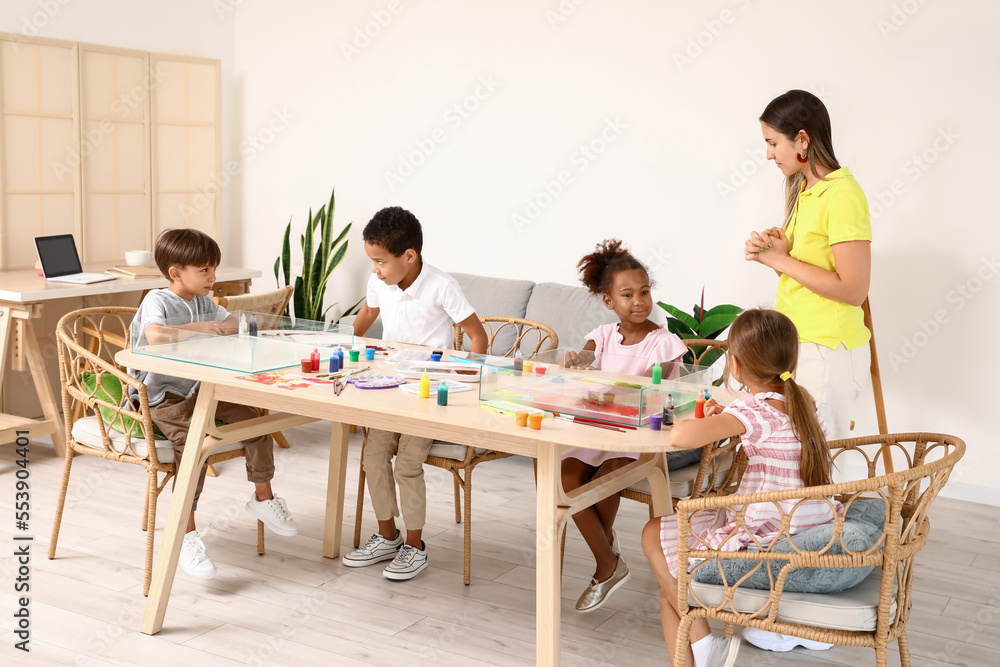 Little children with teacher during master class in Ebru painting at workshop Little children with teacher during master class in Ebru painting at workshop