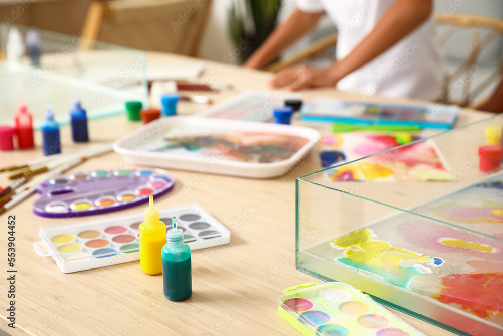 Container with water and paints for Ebru on table in workshop, closeup Container with water and paints for Ebru on table in workshop, closeup