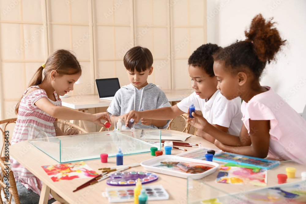 Little children painting on water during master class in Ebru at workshop Little children painting on water during master class in Ebru at workshop