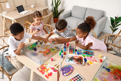 Little children painting on...
