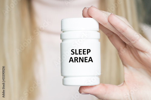 Sleep arnea text on a white jar in the hands of a doctor, a medical concept photo