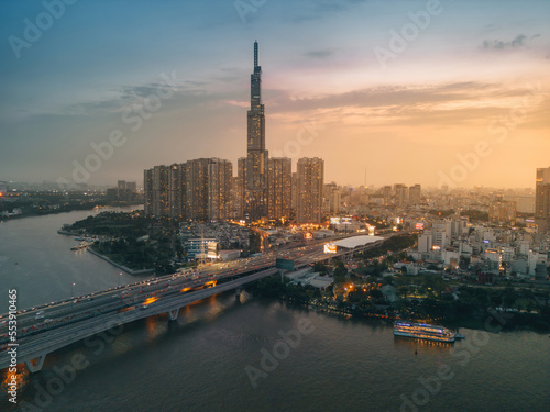 Aerial sunset view at Landmark 81 - it is a super tall skyscraper and Saigon bridge with development buildings along Saigon river, cityscape in the night © CravenA